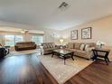 Spacious living room featuring wood floors, plush seating, and natural light at 11141 Sandtrap Dr # 11141, Port Richey, FL 34668
