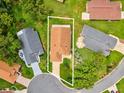 Aerial view of a home in a well-maintained neighborhood with mature trees and manicured lawns at 11350 Copley Ct, Spring Hill, FL 34609