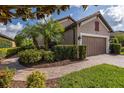 Beautiful single-story home featuring a lush landscaped yard and brick paver driveway at 11611 Callisia Dr, Odessa, FL 33556