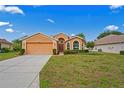 Beautiful single-story home featuring lush landscaping and a two-car garage at 12071 Wexford Blvd, Spring Hill, FL 34609