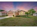 Inviting single-story home with manicured lawn and ample parking in a two-car garage at 12071 Wexford Blvd, Spring Hill, FL 34609