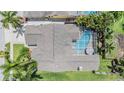 Aerial view of a home with a private screened-in pool and a well-maintained roof at 1222 Starboard Ky, Tarpon Springs, FL 34689