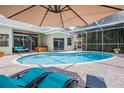 Screened-in pool with lounge chairs at 1222 Starboard Ky, Tarpon Springs, FL 34689