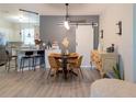 Inviting dining area featuring a stylish table, a sliding barn door, and an open view to the adjacent kitchen at 12408 Country White Cir, Tampa, FL 33635