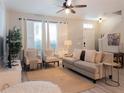 Bright living room featuring neutral tones, comfortable seating, large windows, and stylish decor, perfect for relaxation at 12408 Country White Cir, Tampa, FL 33635
