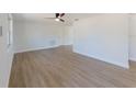 Spacious living room featuring new wood floors, neutral walls, and a modern ceiling fan at 1249 Honor Dr, Holiday, FL 34690