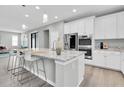 Spacious kitchen with an island, white cabinets, and stainless steel appliances at 12854 Rangeland Blvd, Odessa, FL 33556