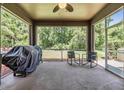 Relaxing screened patio with ceiling fan, overlooking the lush backyard at 1418 Halapa Way, Trinity, FL 34655