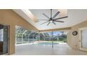 Screened patio with fan overlooking a pool with ample room for entertainment at 18244 Autumn Lake Boulevard, Hudson, FL 34667