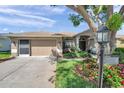 Charming single-story home with a well-manicured lawn, mature landscaping, and a two-car garage at 18520 Hidden Pines Way, Hudson, FL 34667