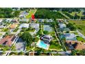Community aerial view featuring homes, tennis courts, and a neighborhood pool nestled among trees at 21820 Carson Dr, Land O Lakes, FL 34639