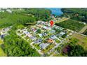 Neighborhood aerial view of a community with lakes and various home styles amid lush greenery at 21820 Carson Dr, Land O Lakes, FL 34639