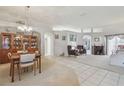 Bright living room featuring tile floors, a fireplace, and elegant furnishings at 22431 Willow Lakes Dr, Lutz, FL 33549