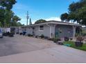 Spacious home with a large driveway, lush landscaping, and mature trees providing ample shade at 3207 Jarvis St, Holiday, FL 34690