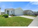 Well-maintained home with a manicured lawn and a driveway, showcasing its appealing curb appeal and neighborhood setting at 33592 Barberry Leaf Way, Wesley Chapel, FL 33543