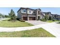 Beautifully landscaped front yard and well-maintained lawn, complemented by a paver driveway and three car garage at 3767 Dragonfly Trl, Odessa, FL 33556