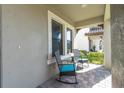 Cozy covered patio featuring outdoor seating, perfect for relaxing and enjoying the serene surroundings at 3767 Dragonfly Trl, Odessa, FL 33556