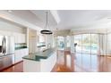 Kitchen featuring a bar area perfect for entertaining with sliding glass doors to the backyard at 4048 St Ives Blvd, Spring Hill, FL 34609
