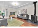Bright living room featuring hardwood floors, a modern fireplace, coffered ceilings, and a comfortable seating area at 435 11Th N Ave, St Petersburg, FL 33701