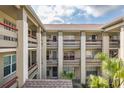 Exterior view of condo building featuring balconies, neutral paint, multiple stories, and staircases at 4575 Whitton Way # 1132, New Port Richey, FL 34653