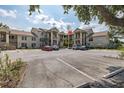 Condo building exterior featuring assigned parking, multiple stories, staircases, and neutral paint at 4575 Whitton Way # 1132, New Port Richey, FL 34653