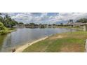 Scenic lake view surrounded by lush greenery and waterfront properties in a quiet community at 4575 Whitton Way # 1132, New Port Richey, FL 34653