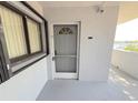 Front entrance with a screen door and a window at 4823 Ebbtide Ln # 105, Port Richey, FL 34668