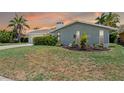 Charming single Gathering home with tropical landscaping, a two car garage, and brick exterior at 4917 Marlin Dr, New Port Richey, FL 34652
