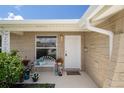 Inviting front porch featuring a bench, flowers, and a charming entrance at 4937 Dory Dr, New Port Richey, FL 34652
