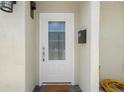 Close-up of the front door featuring a glass window and a welcoming doormat at 5045 Pelican Dr, New Port Richey, FL 34652