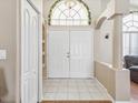 Spacious entryway features double doors, decorative accents, tile flooring and natural light at 6028 Dorset Rd, Spring Hill, FL 34608