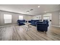 Elegant living room with hardwood floors, recessed lighting, and plush blue furniture at 6222 Cherry Blossom Trl, Gibsonton, FL 33534