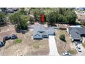 An aerial view of the lovely single-story home with a spacious yard, complemented by a long driveway at 6309 Covewood Dr, Spring Hill, FL 34609