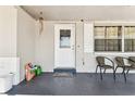 Welcoming front porch with a decorative door, seating, and a glimpse of the home's cozy exterior at 7535 Christina Ln, Port Richey, FL 34668
