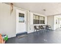 Inviting front porch featuring seating, a 'Welcome' mat, and a decorative door with window accents at 7535 Christina Ln, Port Richey, FL 34668