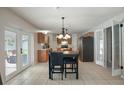 Eat-in kitchen with tile floors, island sink, stainless appliances, and backyard access at 8388 Maltby Rd, Spring Hill, FL 34606