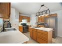 Well-lit kitchen with stainless steel appliances, ample counter space, and wood cabinets at 8388 Maltby Rd, Spring Hill, FL 34606