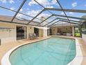Inviting screened-in pool area perfect for relaxation, with comfortable lounge seating and access to the home at 8393 Delaware Dr, Weeki Wachee, FL 34607