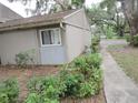 Well-maintained side yard showing partial view of unit at 8640 Lake Isle Dr # 188, Temple Terrace, FL 33637