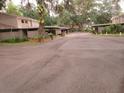 Community parking area featuring covered carports and mature landscaping at 8640 Lake Isle Dr # 188, Temple Terrace, FL 33637