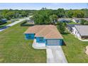 Aerial view of a well-maintained home with a lush green lawn and a spacious driveway at 9251 Geneva St, Spring Hill, FL 34608