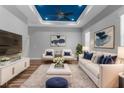 Bright living room with stylish furniture, modern decor, and a blue accent tray ceiling at 9251 Geneva St, Spring Hill, FL 34608