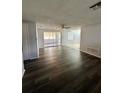Spacious living room with new flooring and a ceiling fan at 10014 Kingswood Ln, Port Richey, FL 34668