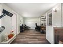 Bright bonus room with wood flooring, storage, an adjacent closet and a work space at 1004 Peninsula Ave, Tarpon Springs, FL 34689