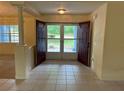 Bright foyer with tile flooring, an open view of the front yard through the front doors at 10054 Hernando Ridge Rd, Weeki Wachee, FL 34613