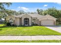 Charming single-story home featuring a well-manicured lawn and inviting facade at 10296 Palmgren, Spring Hill, FL 34608