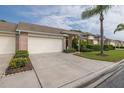 A one-story home featuring a double-car garage, landscaping and a well-manicured lawn at 1105 Flora Vista St, New Port Richey, FL 34655
