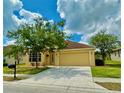 Inviting single-story home with a well-manicured lawn, and an attached two-car garage at 11055 Belle Haven Dr, New Port Richey, FL 34654