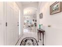 Bright foyer with white tile flooring, elegant archway, and a view of the dining and living areas at 11158 Heathrow Ave, Spring Hill, FL 34609