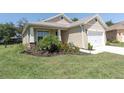 Lush front yard of a well-kept home featuring manicured lawn and colorful flowerbeds at 11308 Mollymawk Ct, New Port Richey, FL 34654